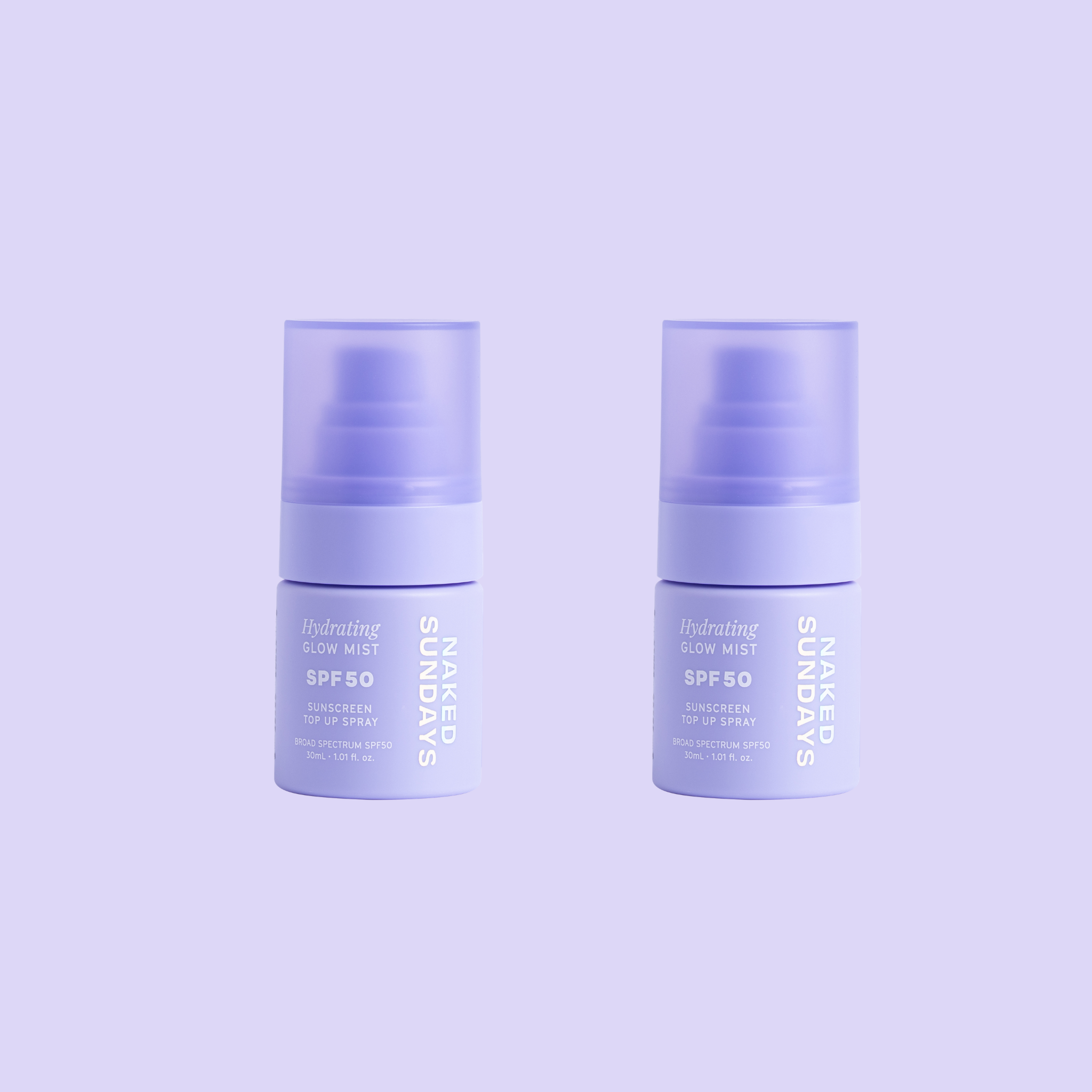 Two bottles of mini-sized Naked Sundays Hydrating Glow Mists SPF50 sitting against a purple background