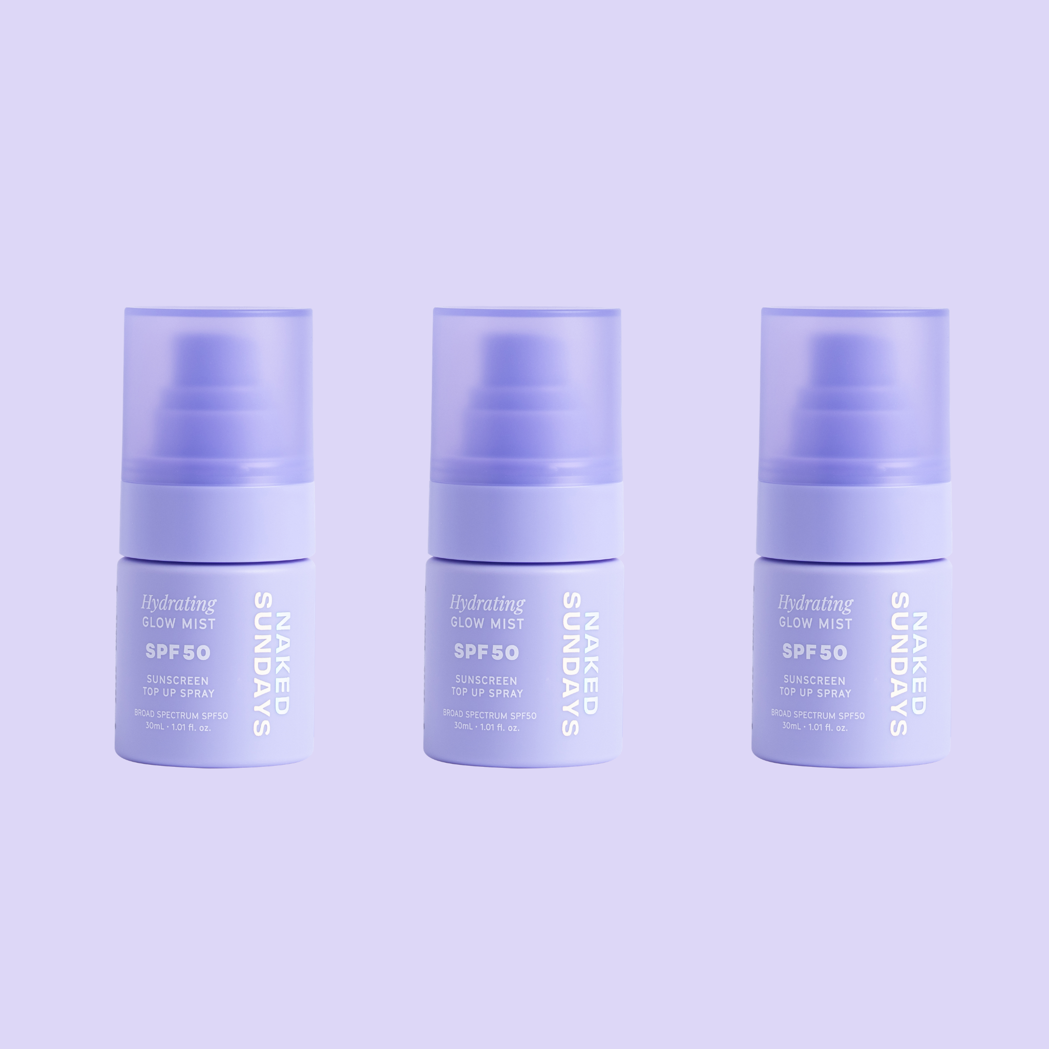 Three mini sized Naked Sundays Hydrating Glow Mists SPF50 sitting against a purple background