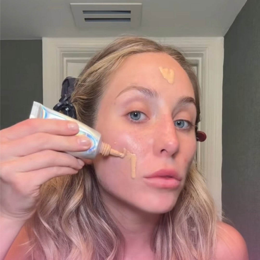 Alix Earle applying Naked Sundays BeautyScreen foundation to their face in Shade 2.5.