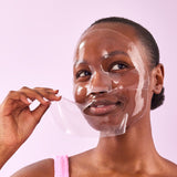Model applying the Naked Sundays Hydrating Hydrogel Sheet Mask to her face.