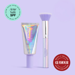 Naked Sundays Beauty sunscreen tube and a Holographic makeup brush on a purple background, featuring 'Acne Safe SPF' and 'Glamour Beauty & Wellness Awards 2026 Winner' badges.