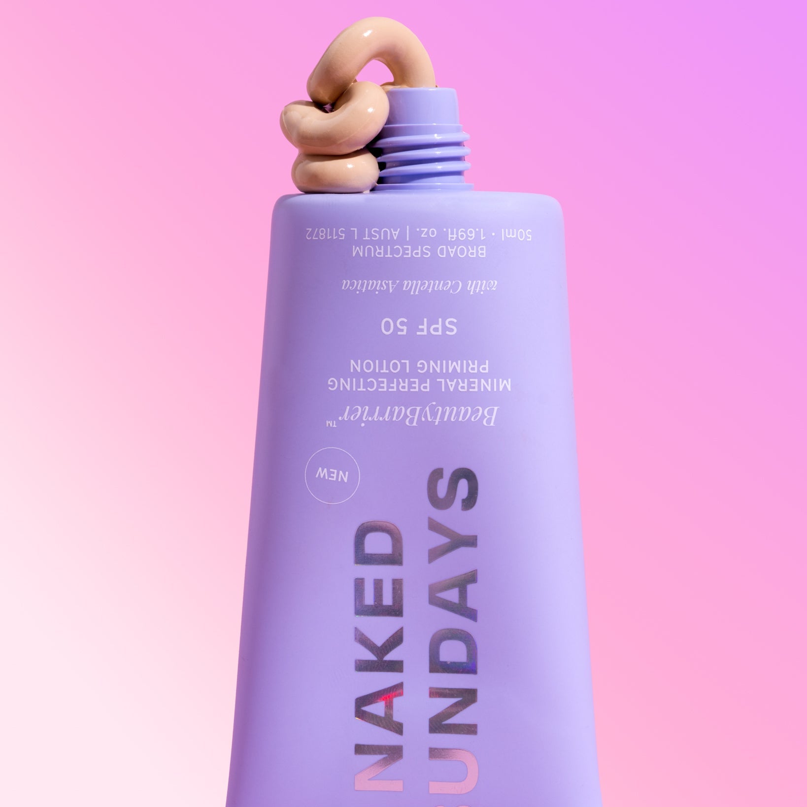 Purple bottle of Naked Sundays BeautyBarrier SPF50 with a pink gradient background