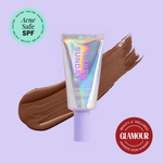 Naked Sundays Beauty sunscreen tube with a swatch on a purple background, featuring 'Acne Safe SPF' and 'Glamour Beauty & Wellness Awards 2026 Winner' badges