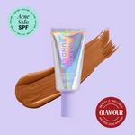 Naked Sundays Beauty sunscreen tube with a swatch on a purple background, featuring 'Acne Safe SPF' and 'Glamour Beauty & Wellness Awards 2026 Winner' badges
