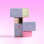 Three Naked Sundays CabanaGlow SPF50 Serum Drops in Blush, Illuminating and Bronze stacked on top of each other on a pink background.