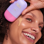Person applying Naked Sundays CabanaMilk Mineral Barrier Fluid to their face