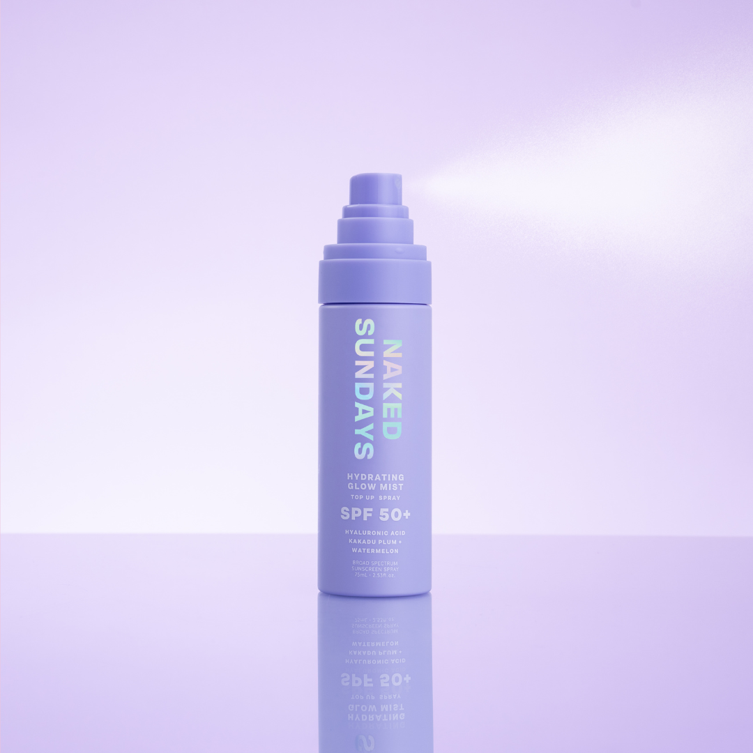 Naked Sundays SPF50+ Glow Mist bottle on a purple background