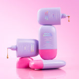 Stack of Naked Sundays CabanaMilk bottles on a pink background