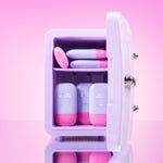 Lilac cosmetics fridge with pink and lilac CabanaMilk SPF50 products on a pink background
