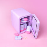 Lilac cosmetics fridge with pink and lilac Cabanamilk SPF50 bottles on a pink background