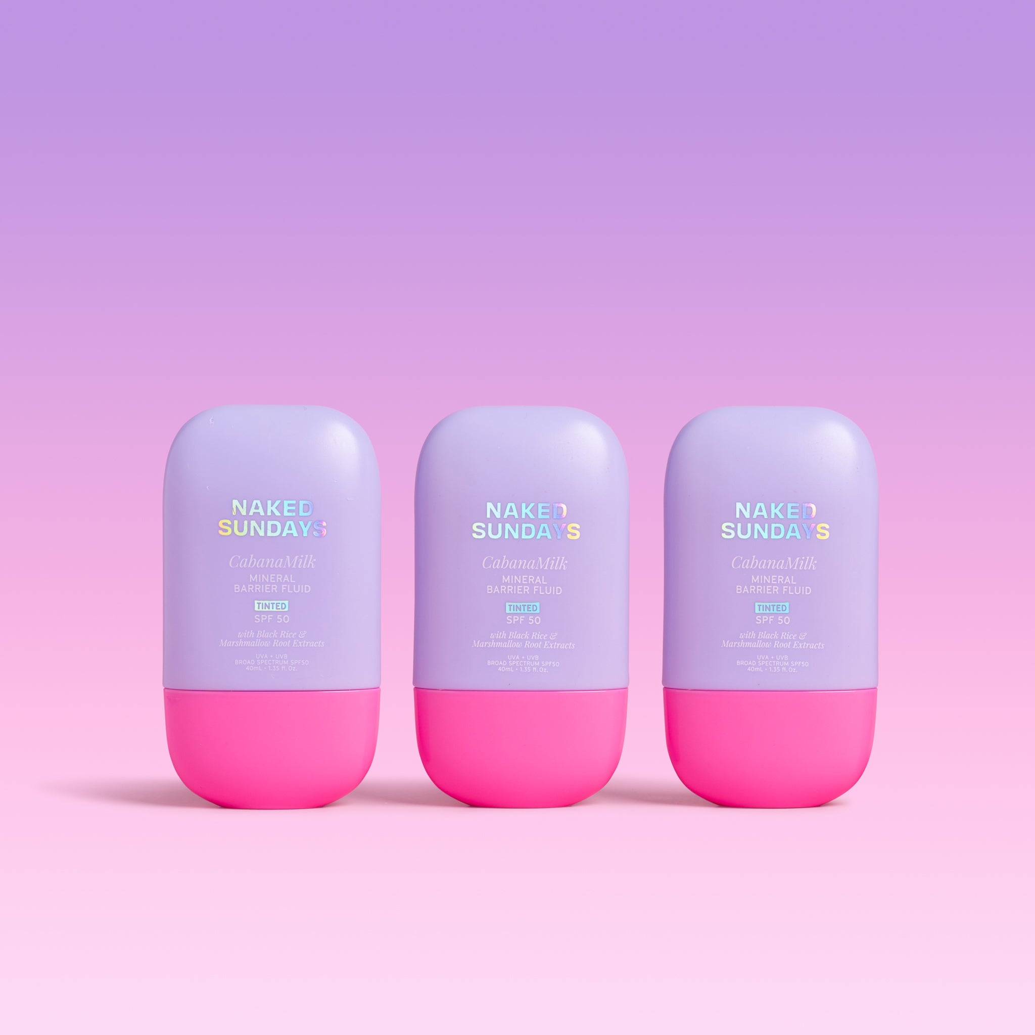 Three bottles of Naked Sundays CabanaMilk Mineral Barrier Fluid SPF50 on a purple background