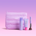 Makeup bag with 'Naked Sundays' branding, accompanied by SPF products and a brush on a pink background