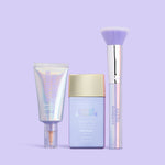Skincare products including a tube, bottle, and brush on a light purple background