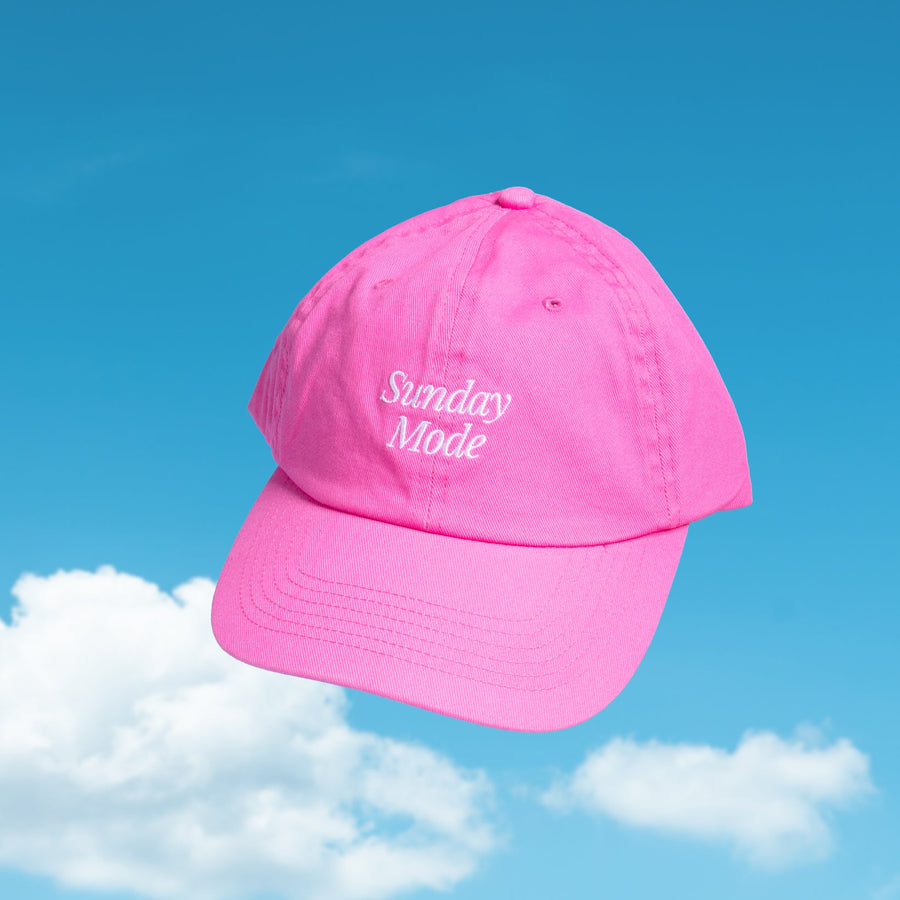 Pink Sunday Mode cap against a blue sky