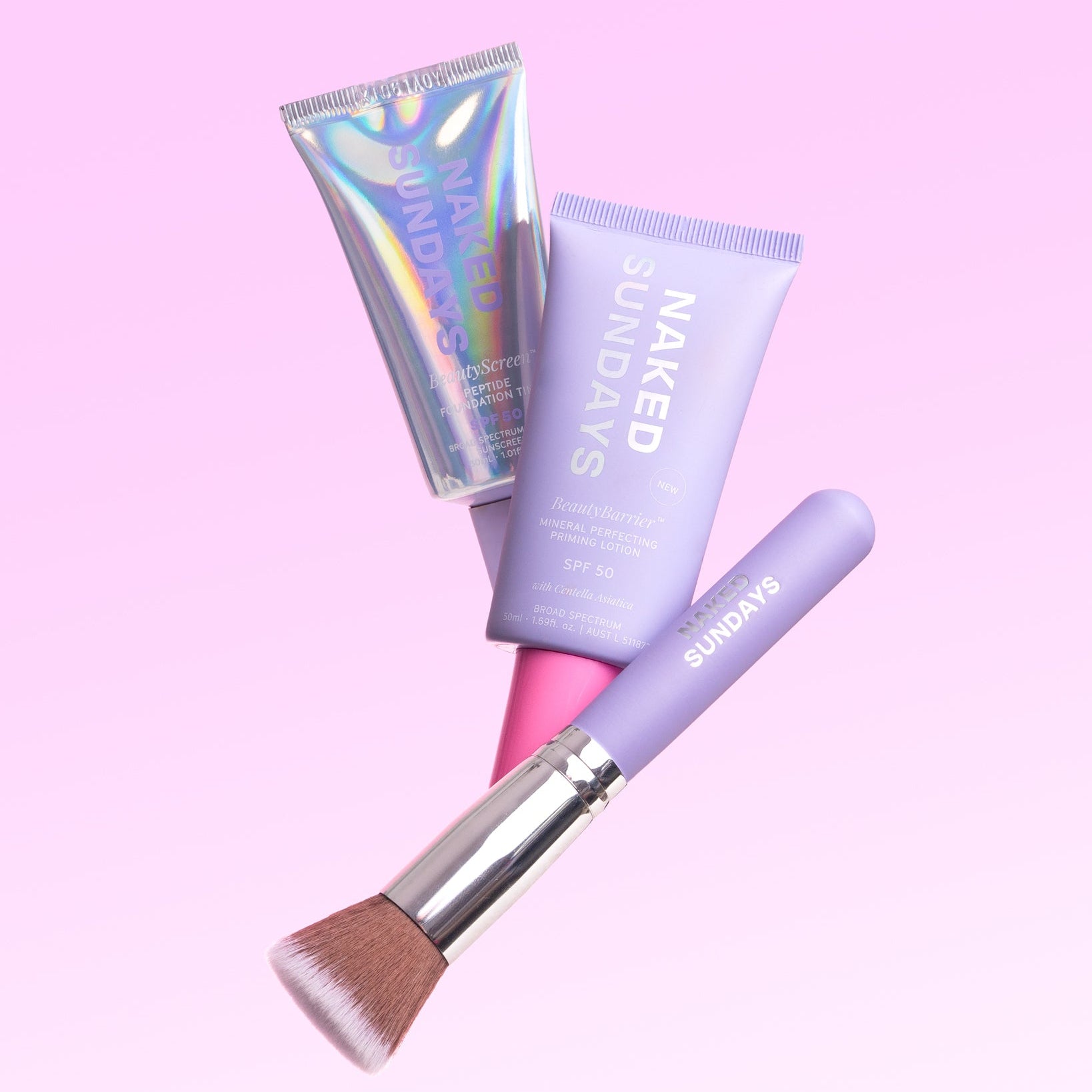 Skincare products and brush with 'Naked Sundays' branding on a pink background