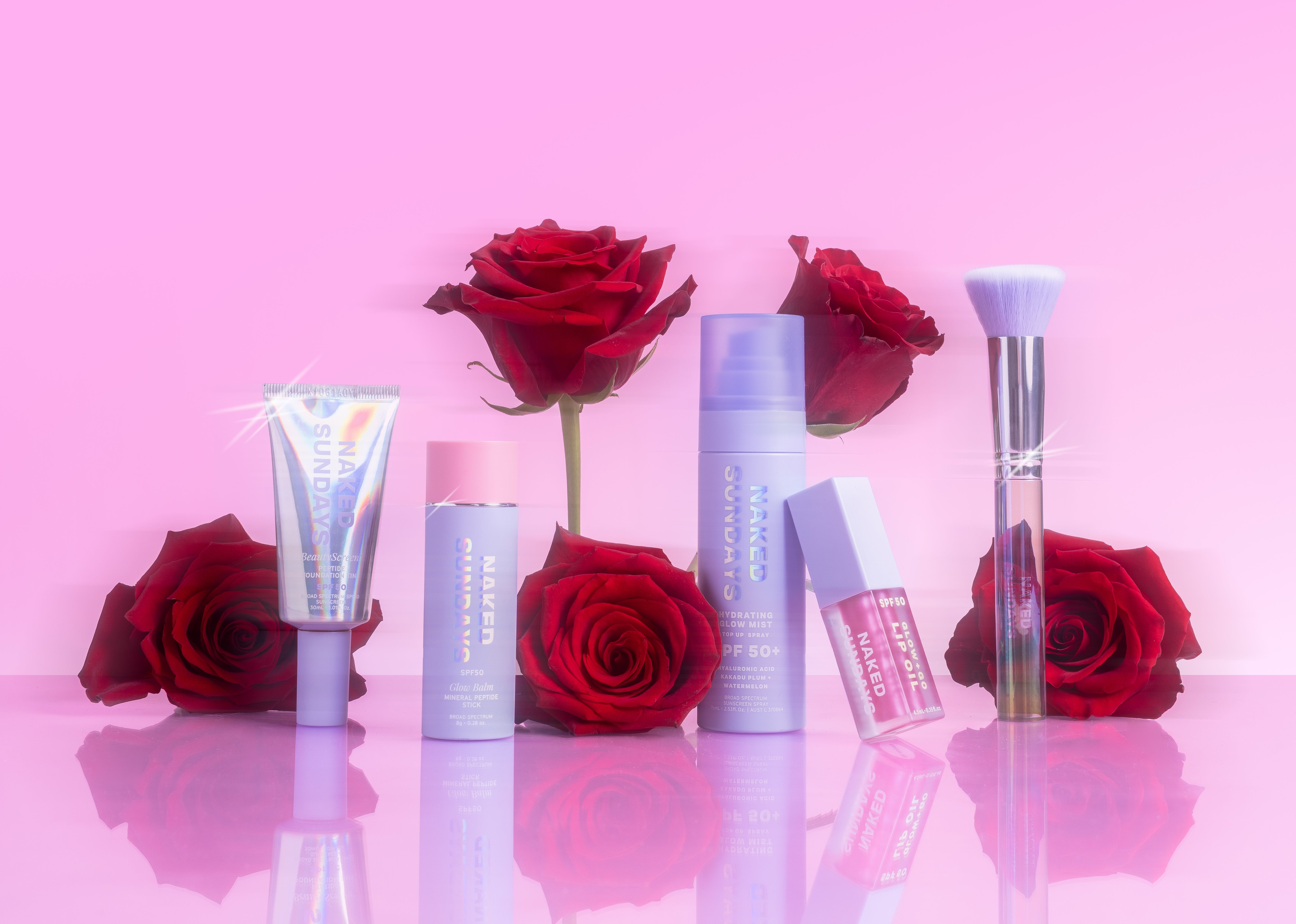 Naked Sundays products with red roses on a pink background