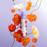 Naked Sundays x Alice & Olivia limited edition SPF50 Hydrating Glow Mist with orange flowers on a purple background