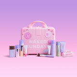 Pink suitcase with Naked Sundays products on a pink background