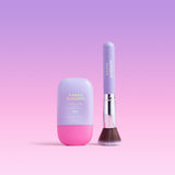Naked Sundays CabanaMilk Mineral Barrier Fluid SPF50 next to a makeup brush on a purple background
