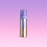 SPF50 Shimmer Mist bottle labeled 'Naked Sundays' on a gradient purple background