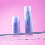 Hydrating Glow Mist full size and mini size next to each other on a pink background with water droplets