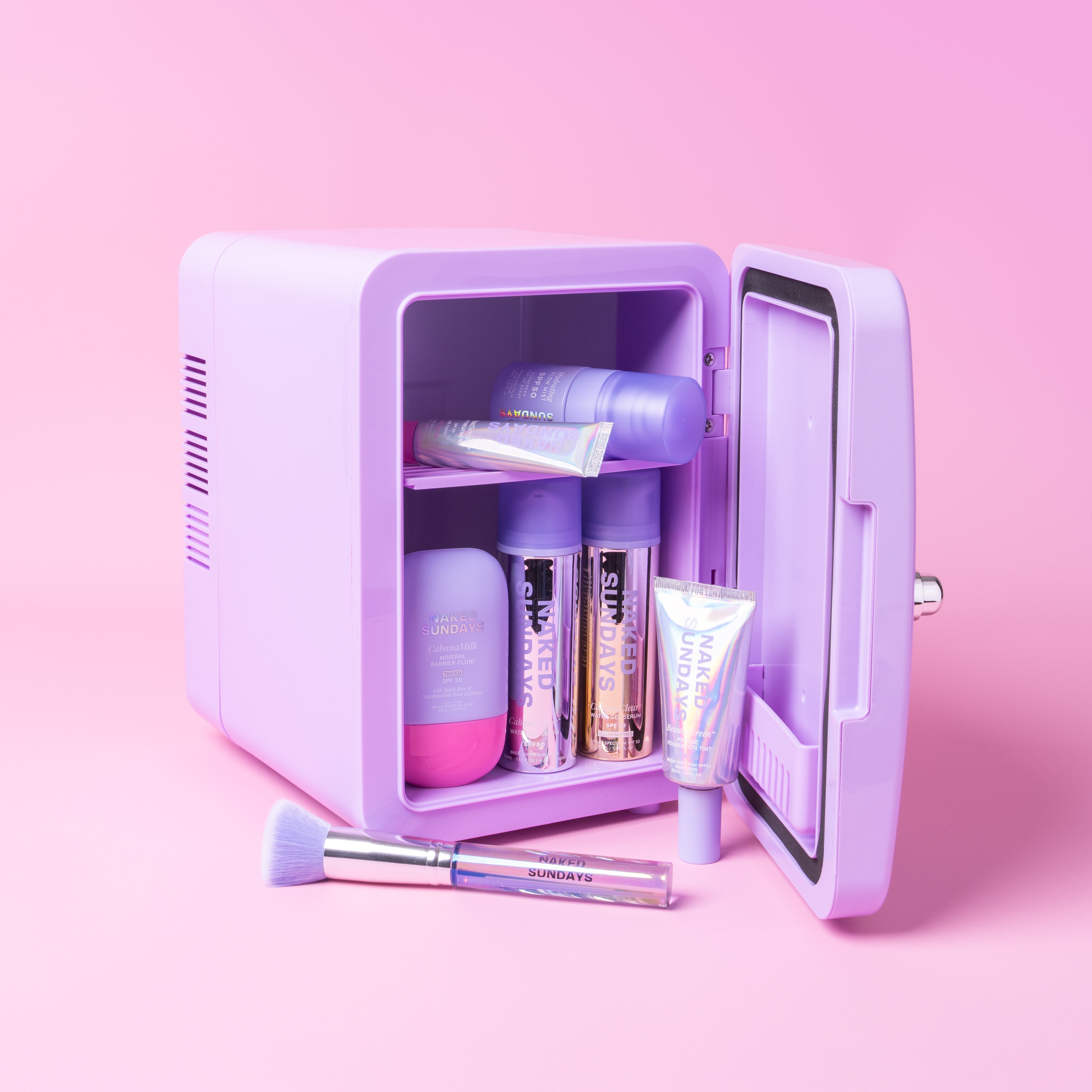 Small purple refrigerator with Naked Sundays products on a pink background