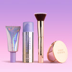 SPF Makeup products including BeautyScreen, CabanaClear in Illuminating, a gold compact mirror, and a gold brush with 'Naked Sundays' branding on a gradient pink and purple background