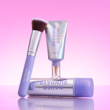 Naked Sundays Glow and Go Bundle containing a bottle of BeautyScreen, CabanaClear and the SPF BFF Brush. All products are sitting against a pink/holographic background.