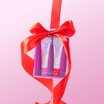 Naked Sundays PoutScreen SPF50 lip treatment duo in pink and red shades, packaged in a gift box with a red ribbon
