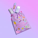 Naked Sundays Drawstring bag featuring 'Hot Girl Sunscreen' in pink text. Three Naked Sundays SPF50 products are coming out of the bag against a purple background.