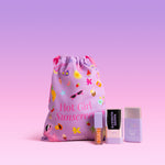 Naked Sundays Resort Era Drawstring bag featuring 'Hot Girl Sunscreen' in pink text. Next to the bag is Naked Sundays SPF50 Glow + Go Lip Oil in Salted Caramel, Cabana Glow SPF50 Mineral Serum Drops in shade Sheer Tint and Clear Glow Sun Stick SPF50.