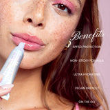 Woman applying Naked Sundays PoutScreen with product benefits listed on a light pink background