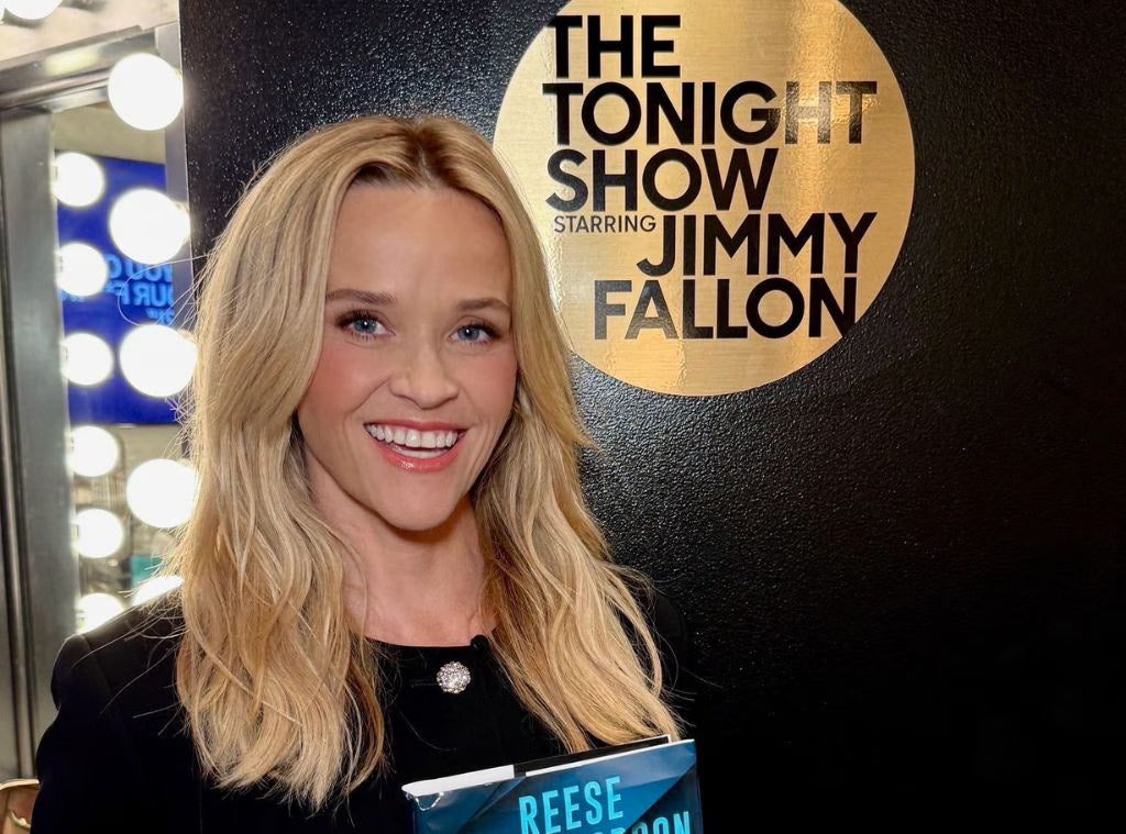 Reese Witherspoon standing in front of 'The Tonight Show Starring Jimmy Fallon' logo