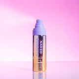 Bottle of Naked Sundays Golden Glow Shimmer Mist SPF50 sitting on a pink surface