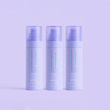 Three bottles of Naked Sundays Mist with a purple background