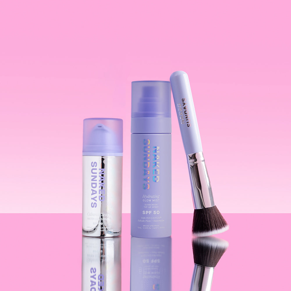 Two Naked Sundays SPF products and a brush on a pink background