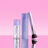 Two Naked Sundays SPF products and a brush on a pink background