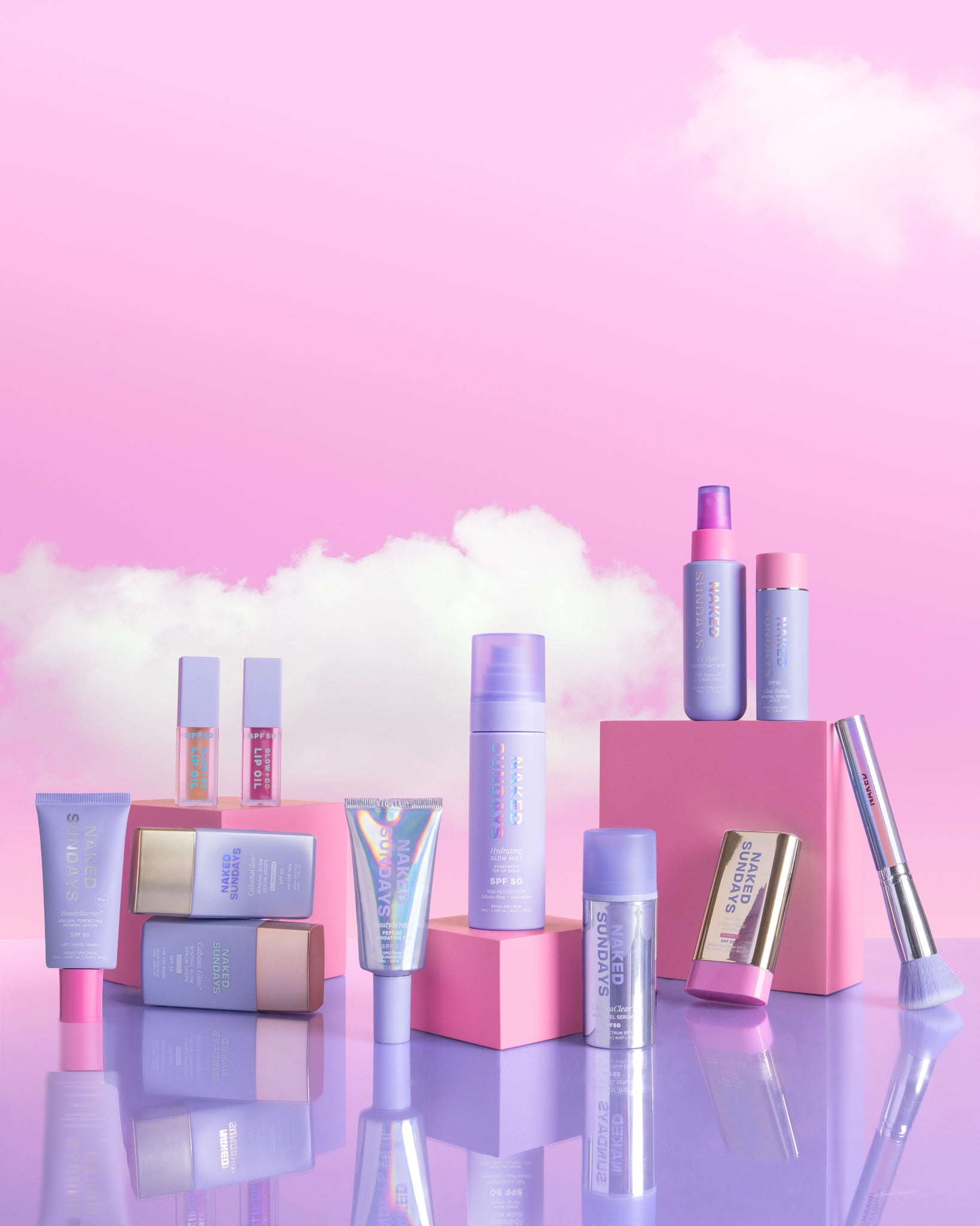 Ultimate Glow Bundle with a pink and purple color scheme on a reflective surface with a pink background.