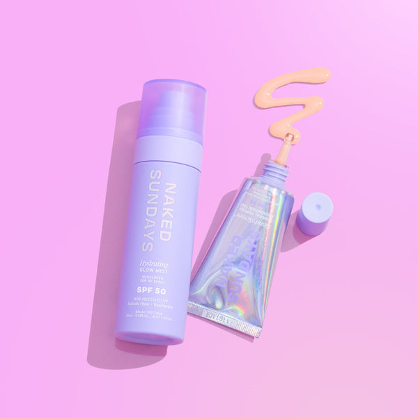 Naked Sundays Hydrating Glow Mist SPF 50 in a lavender spray bottle next to an tube of BeautyScreen SPF50 Skin Tint on a pink background.