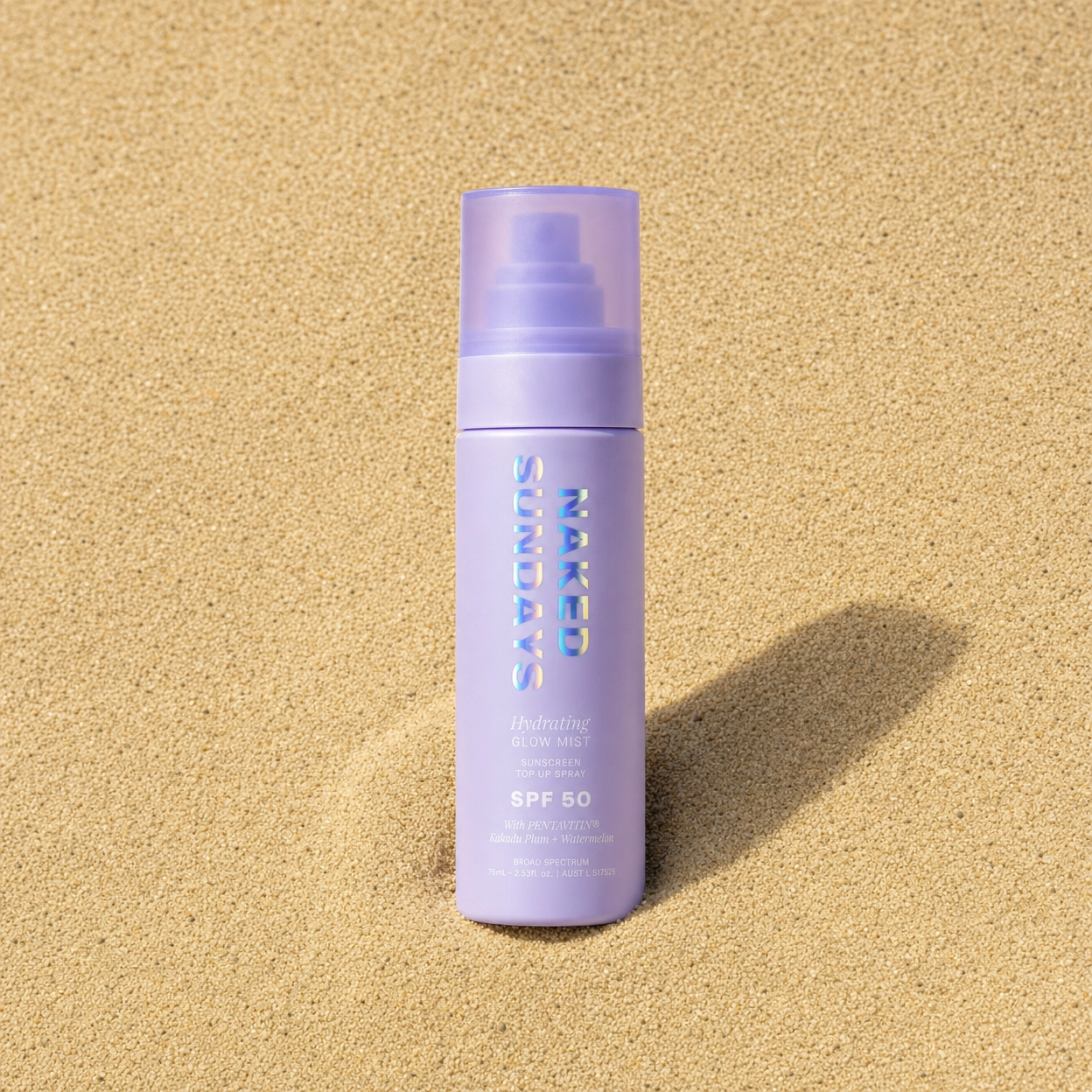Hydrating SPF50 Glow Mist on a sandy beach