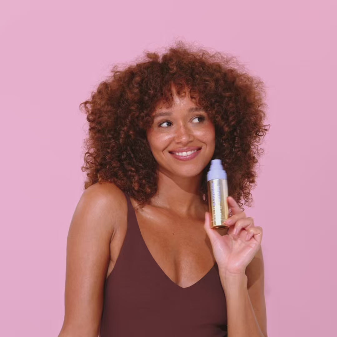 Short video of a woman applying Naked Sundays Hydrating Shimmer Mist SPF50 Setting Spray to her hands, arms and body.