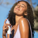 Glow Body Mist SPF50+ - Model Using Bottle